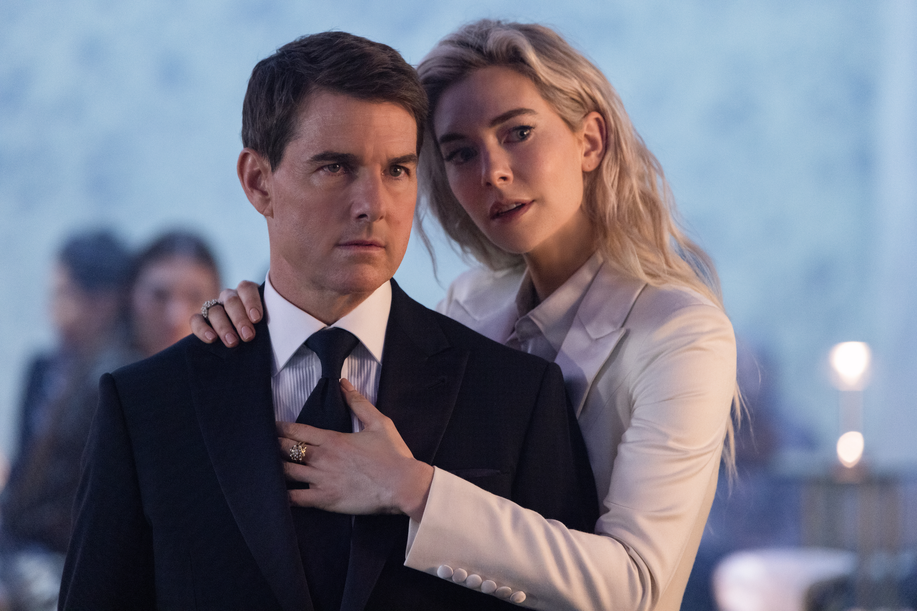 Ethan Hunt (Tom Cruise) looks particularly uncomfortable and dead-eyed wearing a suit and standing in a brightly backlit nightclub next to Alanna Mitsopolis, the White Widow (Vanessa Kirby), a blonde woman in white who’s all up in his personal space and playing with the knot on his necktie in Mission: Impossible – Dead Reckoning Part One