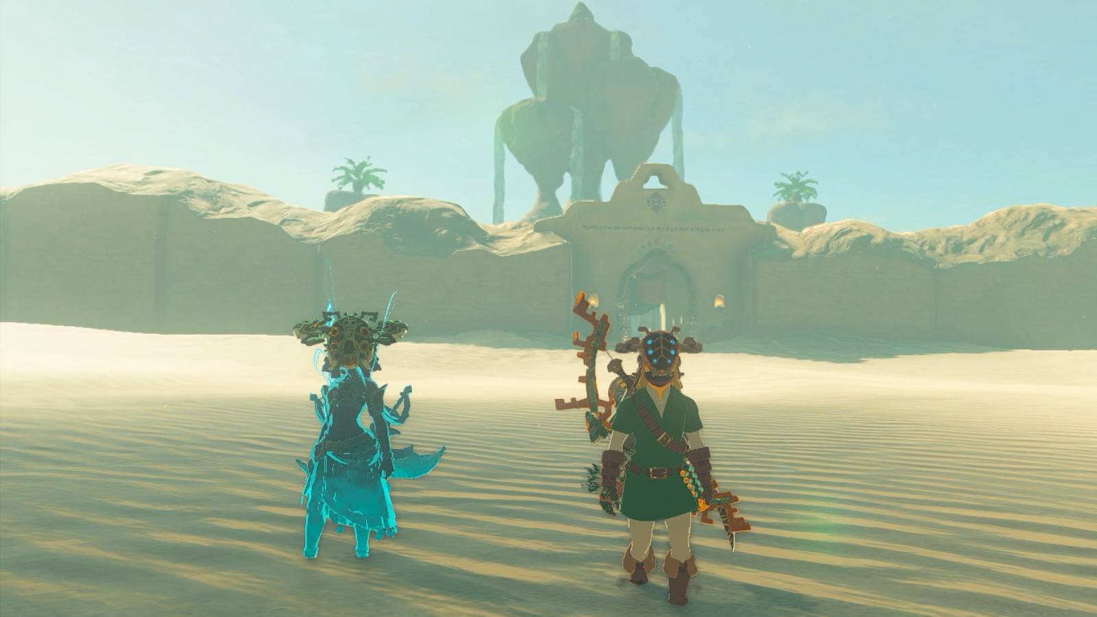 Link and Riju’s avatar wearing the Vah Naboris Divine Helm in front of the Gerudo Village in The Legend of Zelda: Tears of the Kingdom.